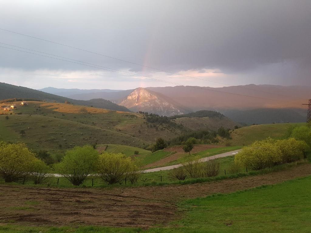 a mountain in the distance with a road in a field at Guest House Chala in Chala