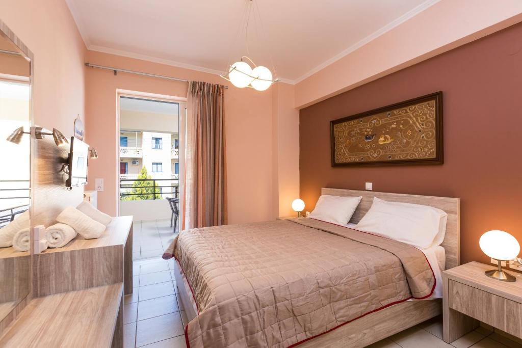 a hotel room with a bed and a balcony at Cozy Guest House in Rethymno Town