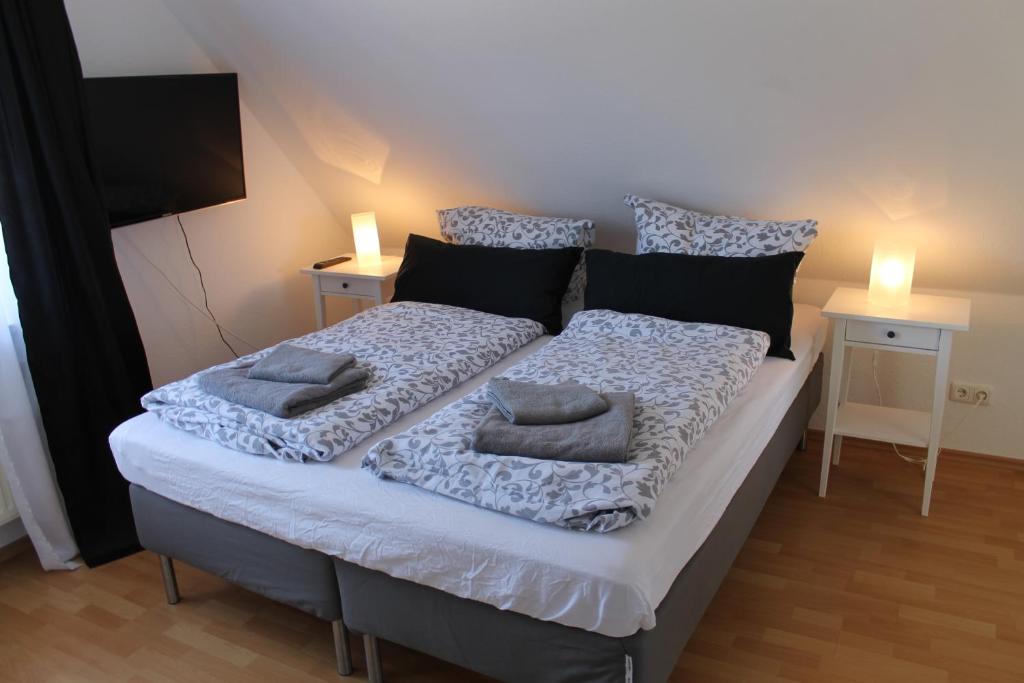 a bed with two pillows on it in a room at Haus Fischkutter in Leezdorf