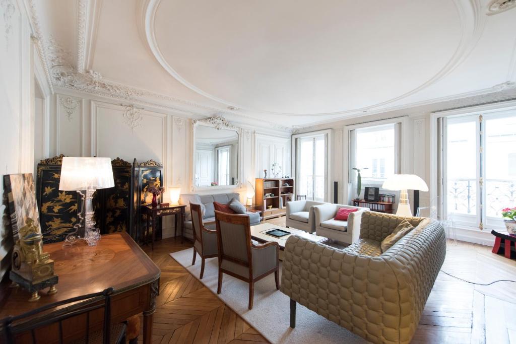 a living room with a couch and a table at Veeve - Charming Haussmannian in Paris