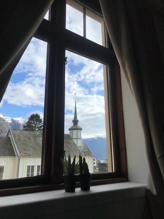 a window with a view of a church at Valldal Gjestgiveri in Valldal