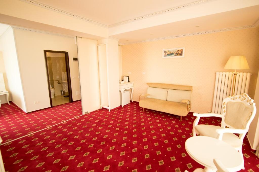 a hotel room with a bed and a red carpet at MSR Port Hotel in Mangalia