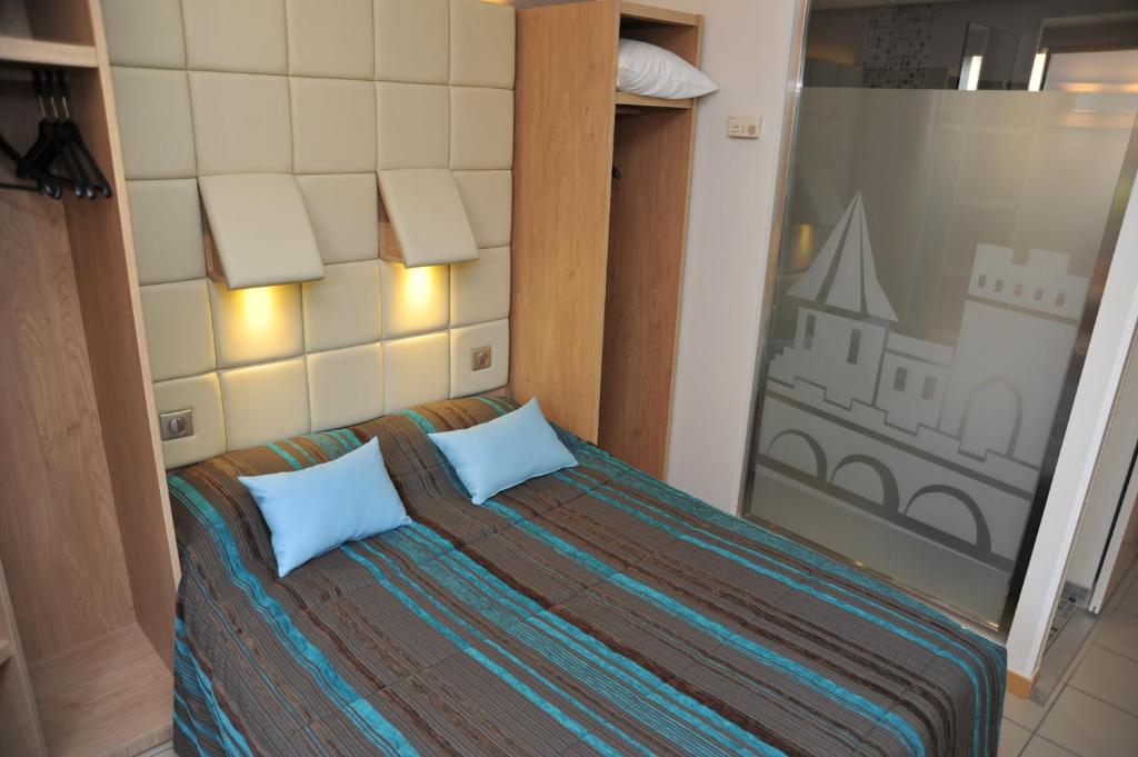 Postel nebo postele na pokoji v ubytování Hotel Espace Cite