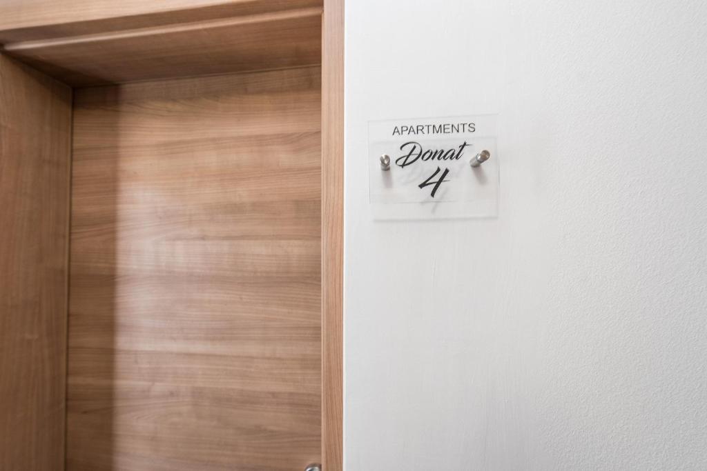 a door with a sign that readsaudiences journal x at Apartments Donat in Zadar