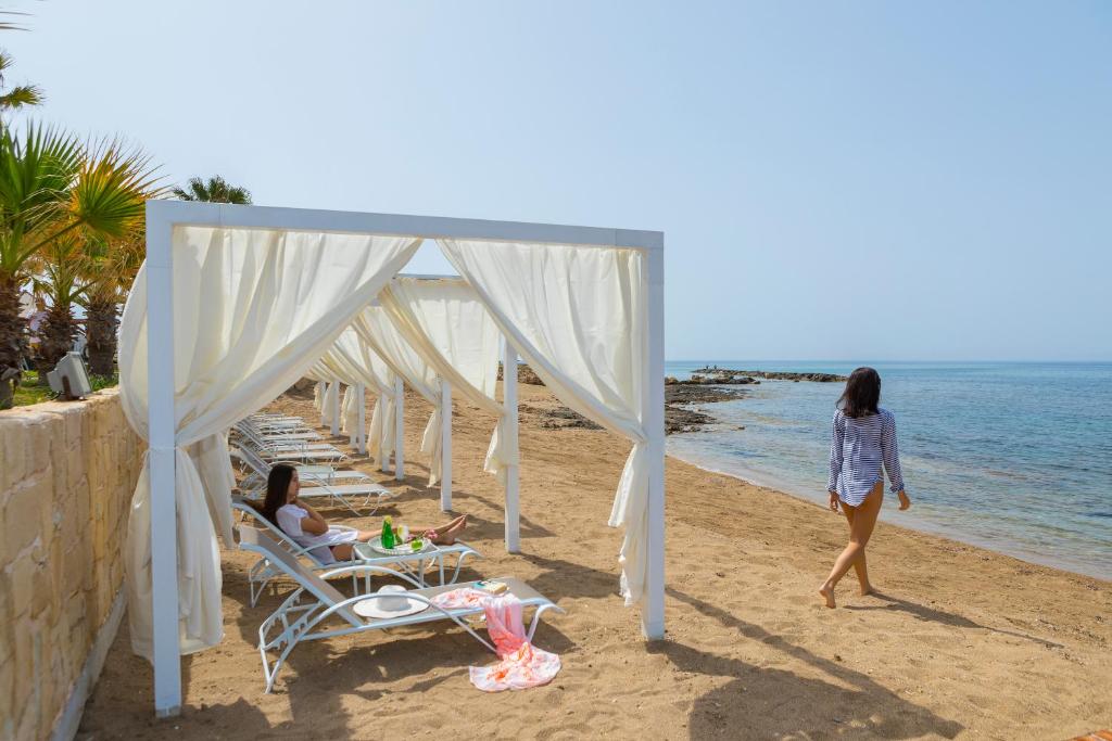 a group of women walking on the beach at Aquamare Beach Hotel & Spa in Paphos