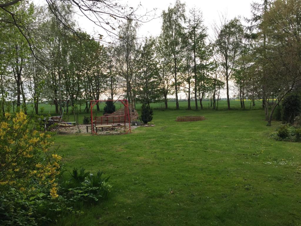 a park with a bench in the middle of a field at Gartenidyll Insel Rügen Poppelvitz bei Altefähr in Altefähr