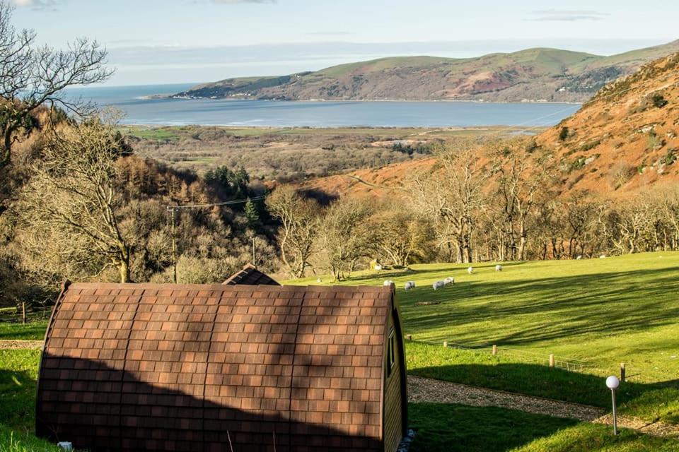 a roof of a house with a view of a field at Bwlcheinion Sea View Glamping in Machynlleth