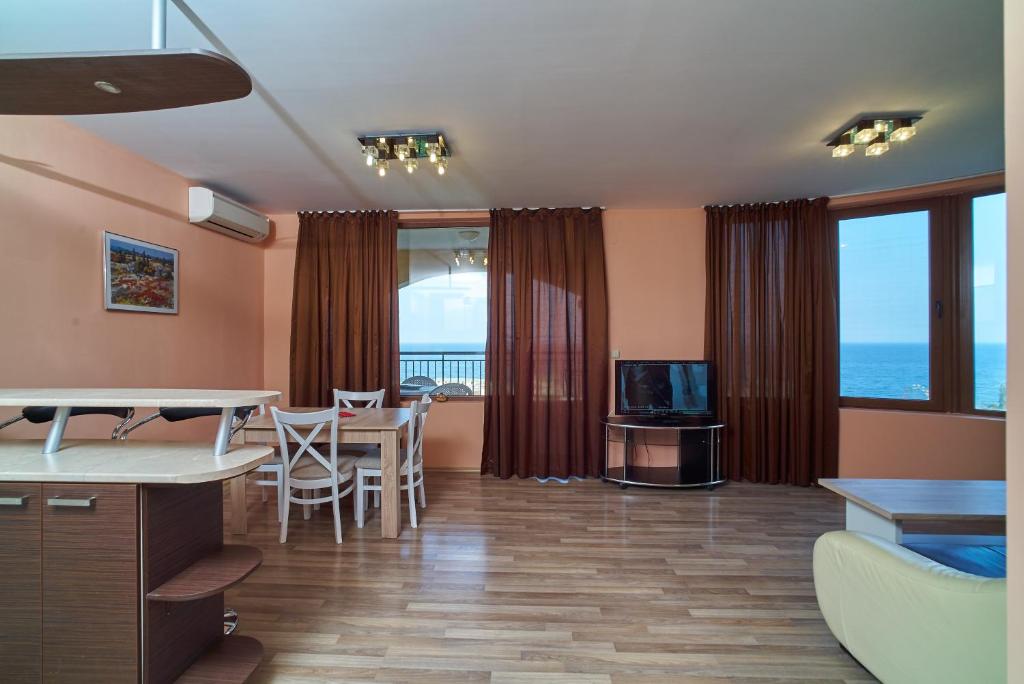 a living room with a view of the ocean at Sea Panorama Apartments Golden sands in Golden Sands