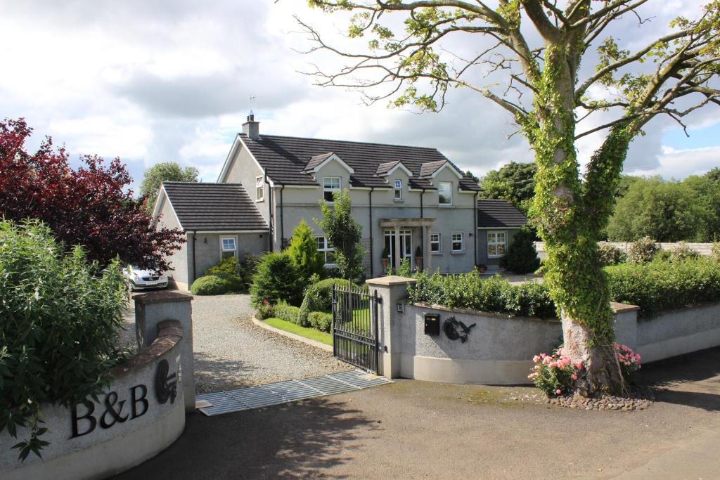 a large house with a gate in front of it at Crowfield Country House in Aghadowey