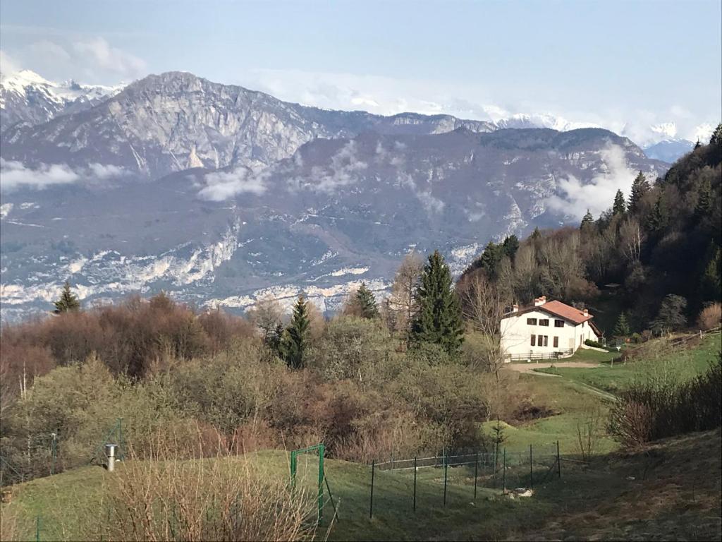 a house on a hill with mountains in the background at Trentino in malga: Malga Zanga in Arco
