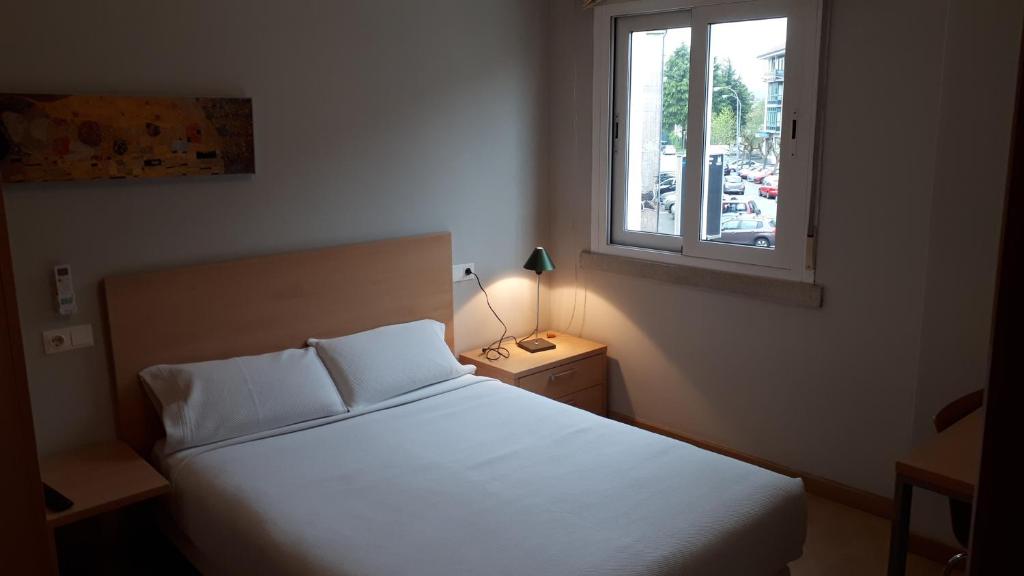 Een bed of bedden in een kamer bij PR Blanco