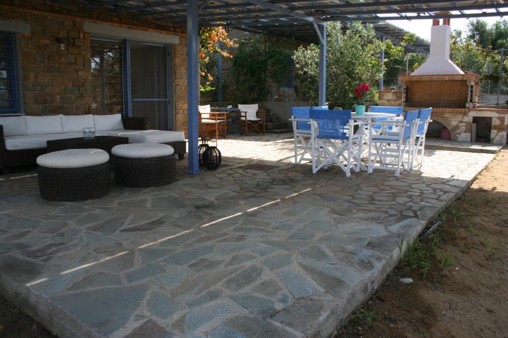 a patio with chairs and a table and a grill at Casa Di Mare in Methoni