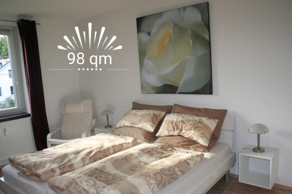 a bedroom with a bed and a picture on the wall at Orange Sun Apartment in Braunschweig