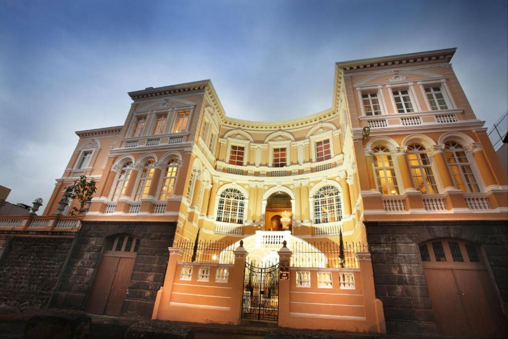 a large building with a gate in front of it at Boutique Hotel Mansion del Angel in Quito