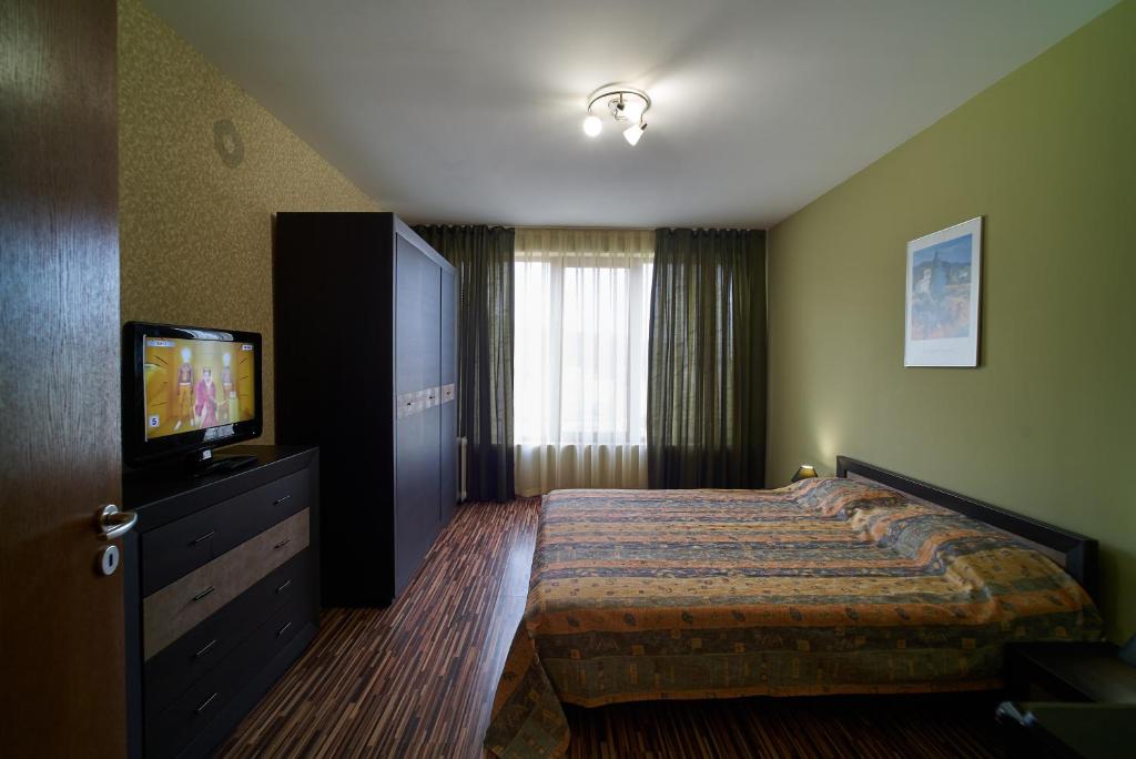 A bed or beds in a room at Sea Panorama Apartments Golden sands