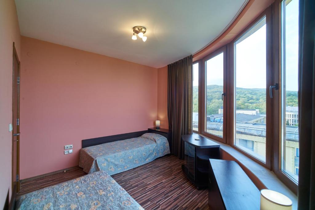 A bed or beds in a room at Sea Panorama Apartments Golden sands