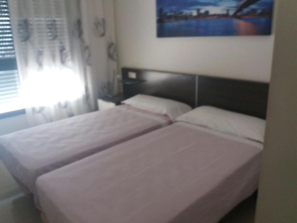 Postel nebo postele na pokoji v ubytování Apartment Carmentxu Gemelos 26