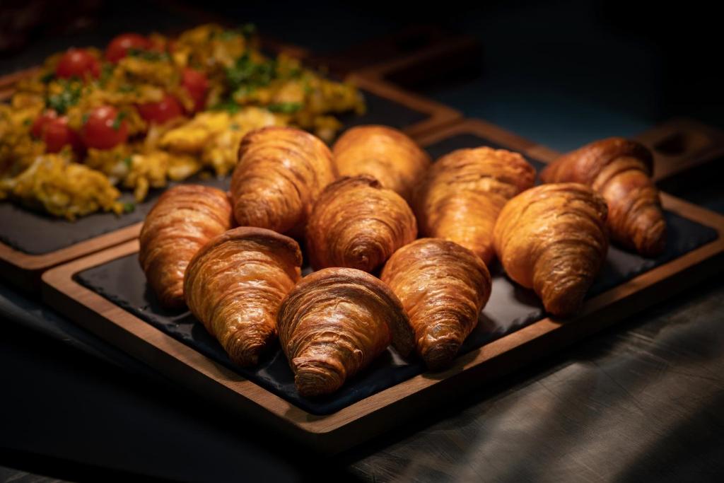 a tray of croissants and other food on a table at Boutique Hotel Glacier in Grindelwald