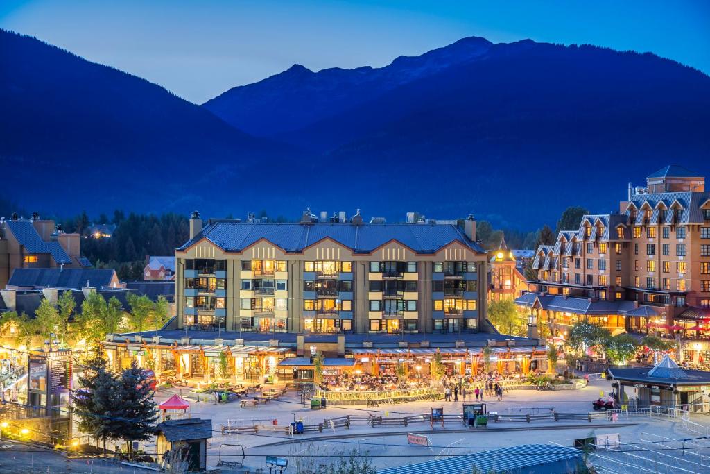a large building with christmas lights in a town at night at Carleton Lodge in Whistler
