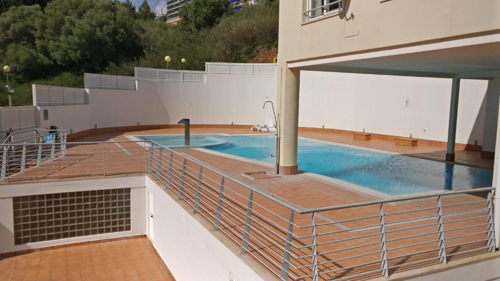 a swimming pool on the roof of a building at Sesimbra Oasis Apartment in Sesimbra