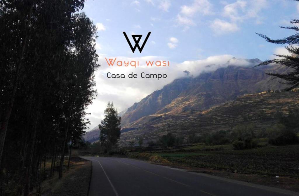 a view of a road with mountains in the background at Wayqi Wasi in Pisac