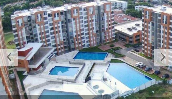 an aerial view of a building with two swimming pools at Reserva del Peñon in Girardot