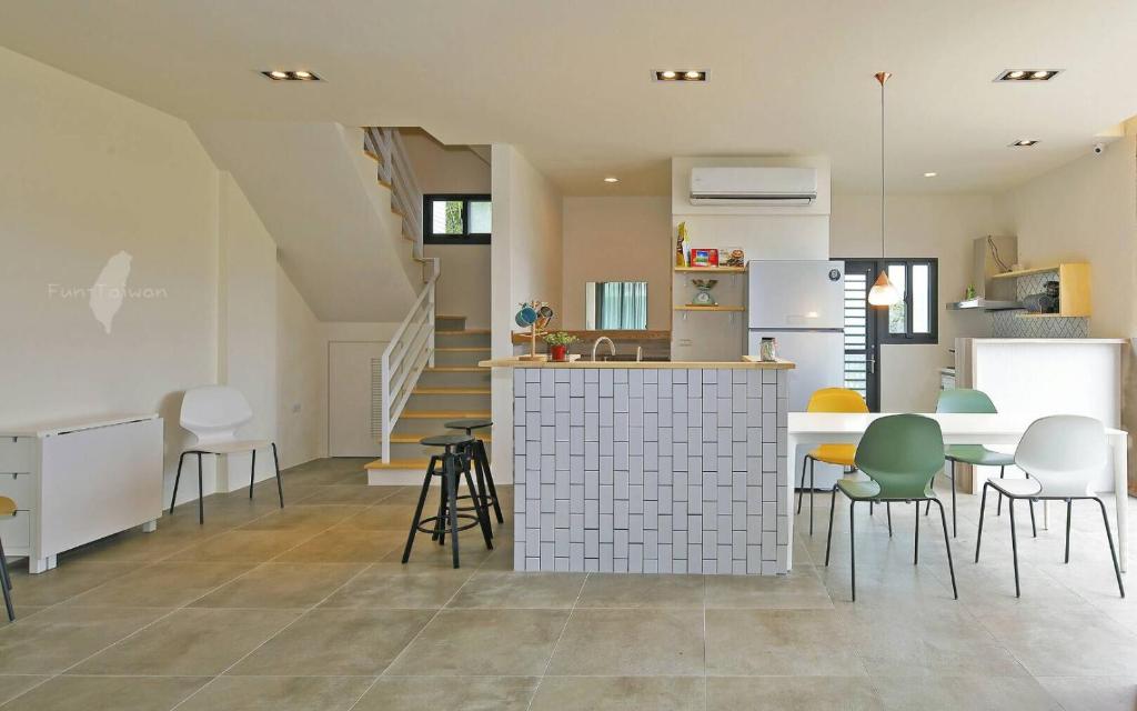 a kitchen and living room with a table and chairs at Less is more in Wujie