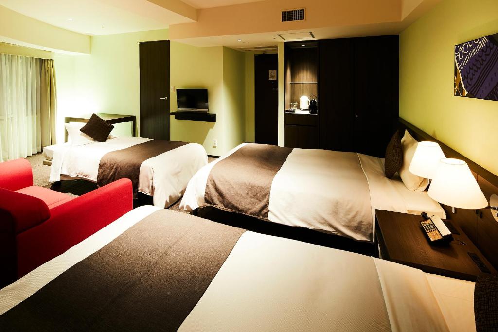 Postel nebo postele na pokoji v ubytování Ginza Grand Hotel