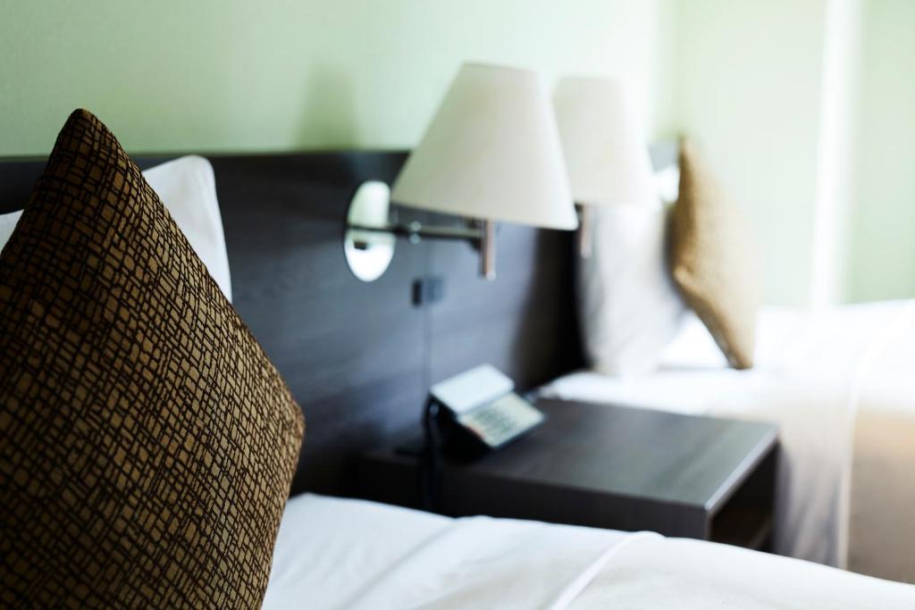 Postel nebo postele na pokoji v ubytování Ginza Grand Hotel