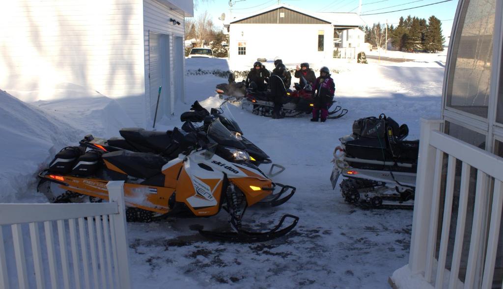 a couple of motorcycles parked in the snow at Les Gites Makadan in Normandin
