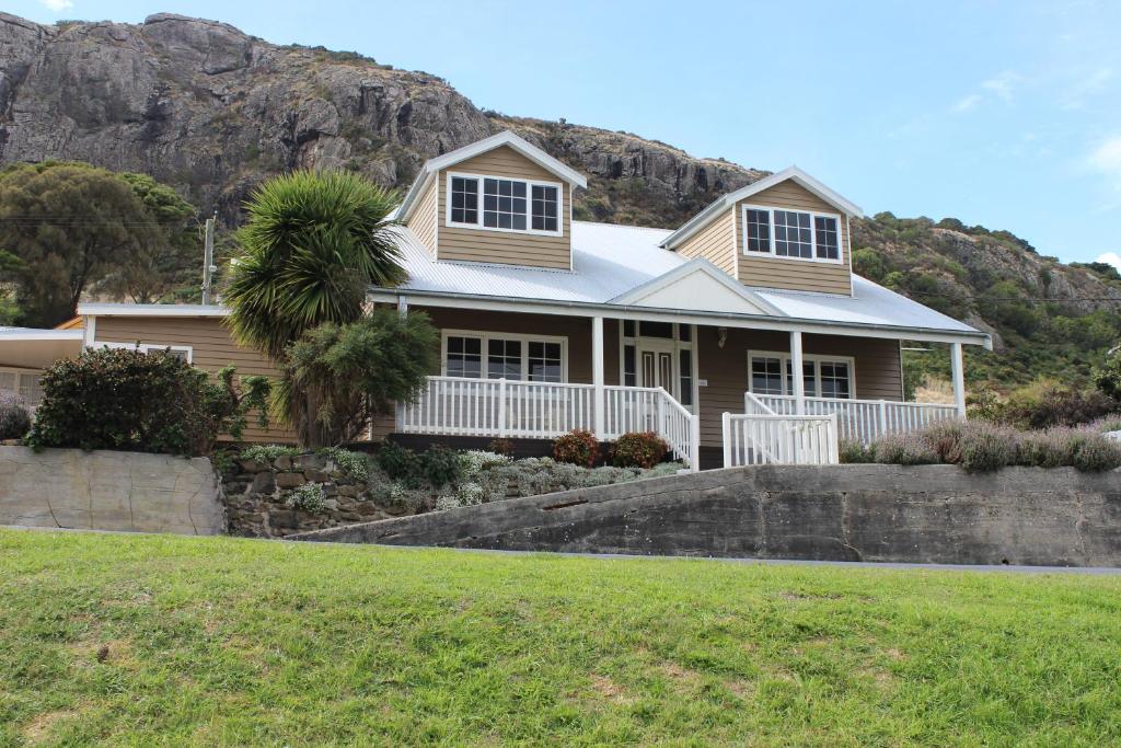 a house with a mountain in the background at The Ark Stanley Luxury Bed and Breakfast in Stanley