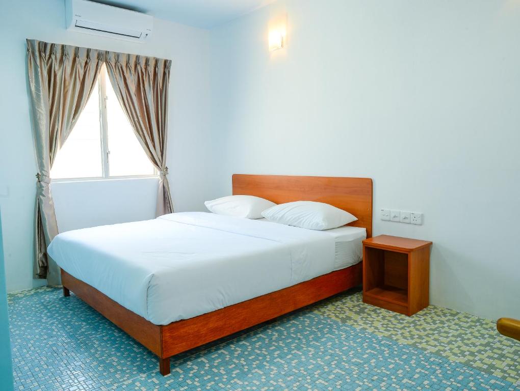 Postel nebo postele na pokoji v ubytování MG Hotel