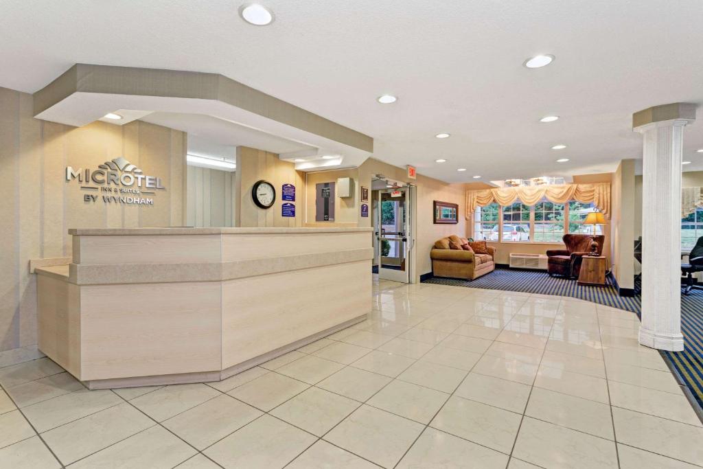 a lobby of a mmorton pharmacy with a waiting room at Microtel Inn & Suites by Wyndham Florence/Cincinnati Airpo in Florence