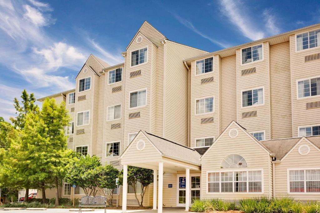 a large apartment building with a building at Microtel Inn & Suites by Wyndham Daphne in Daphne