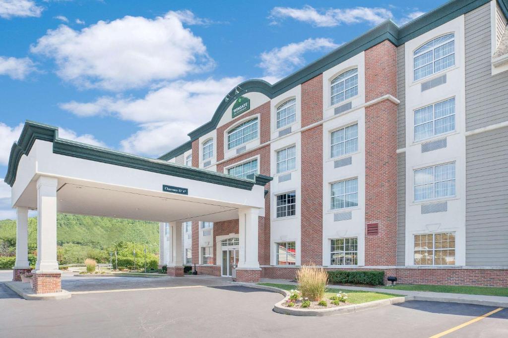 a large building with a parking lot in front of it at Wingate by Wyndham Ellicottville in Ellicottville