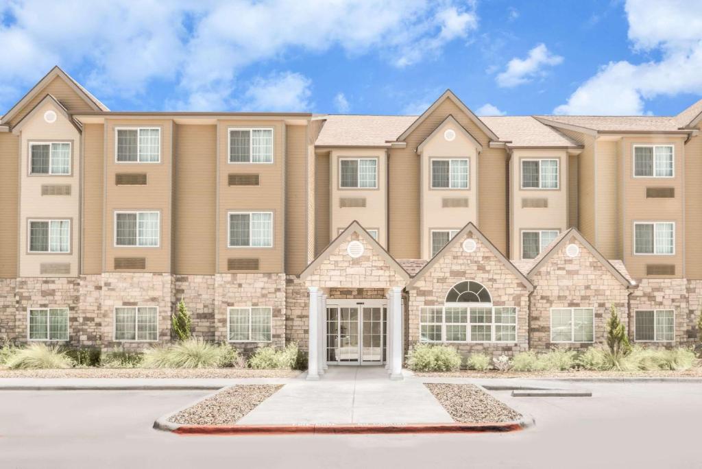 a large apartment building with a front door at Microtel Inn & Suites by Wyndham in Midland