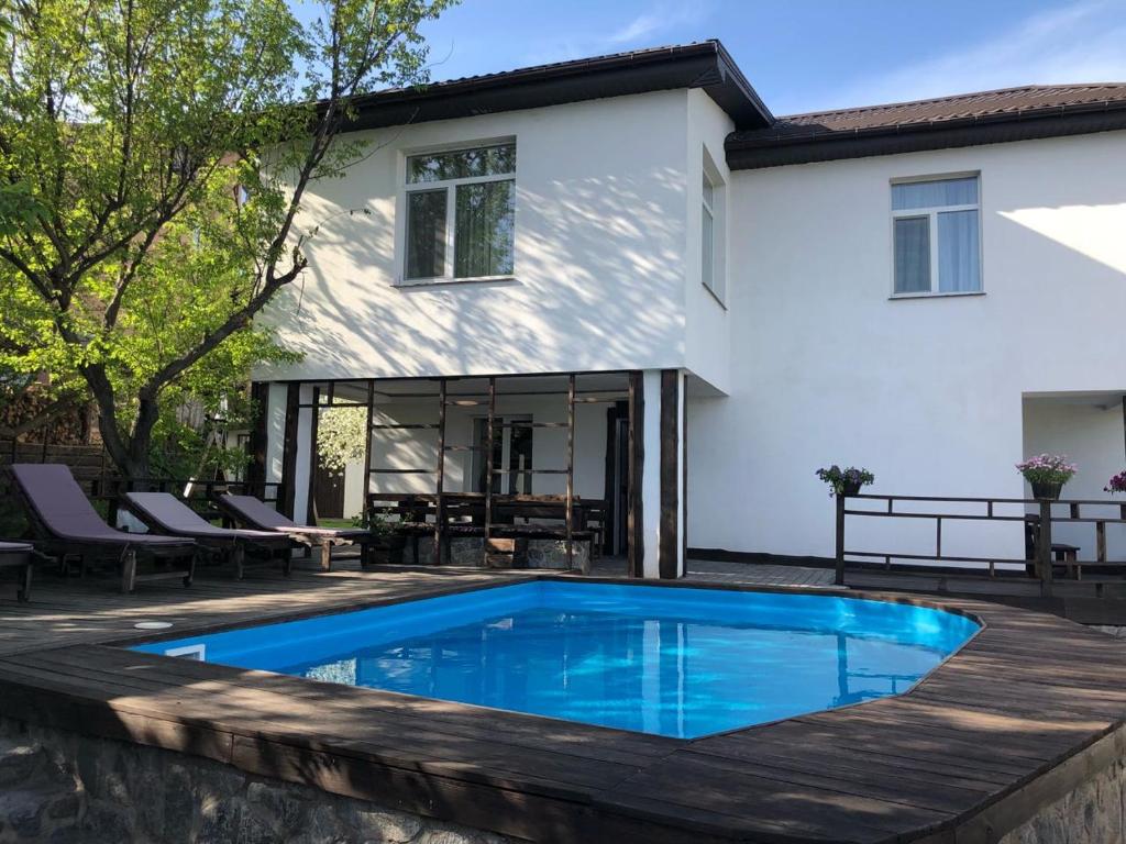 a swimming pool in front of a house at Dniprovskiy Dvir in Dnipro