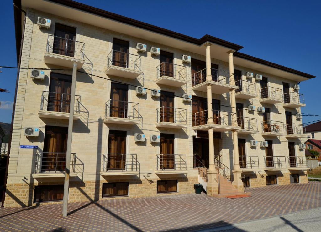 a building with balconies on the side of it at Hotel Acropolis Palace in Kabardinka