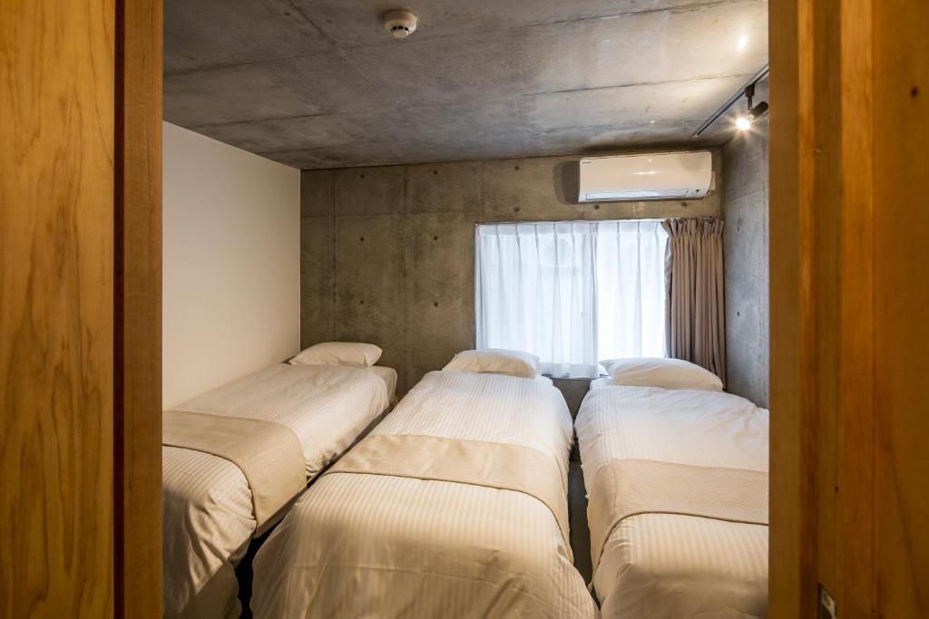 Postel nebo postele na pokoji v ubytování Smi:re Stay Oshiage