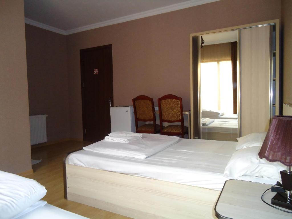 Postel nebo postele na pokoji v ubytování Hotel Nikala