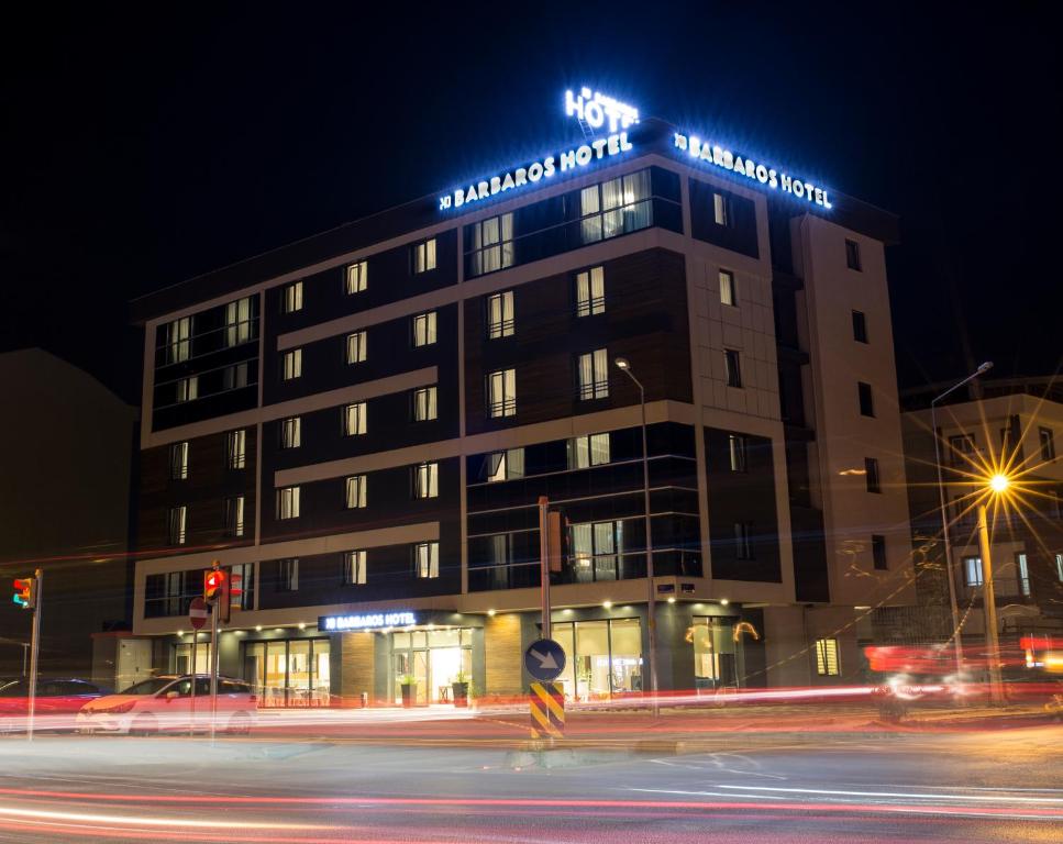 a building on a street at night with traffic at MD Barbaros Hotel in Canakkale