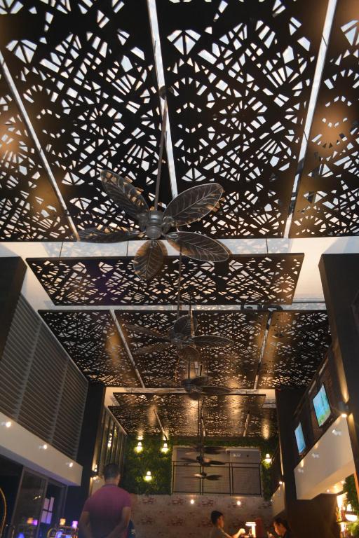 a ceiling of a building with a ceiling fan at Cuna Hotel in El Nido