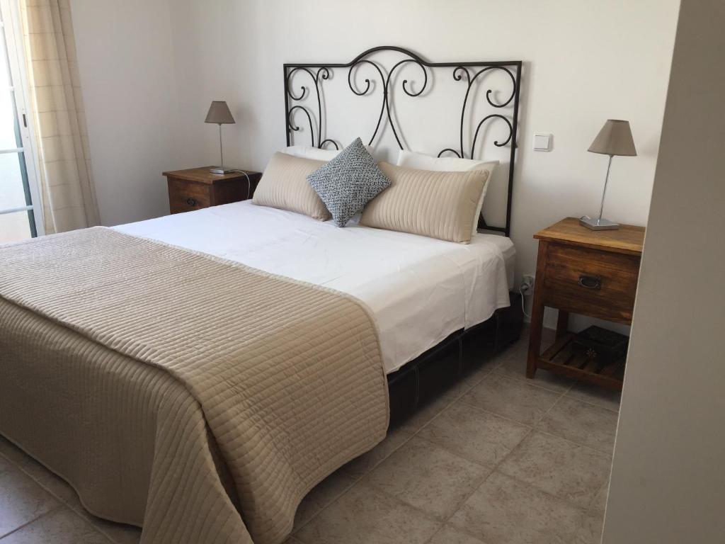 a bedroom with a large white bed with pillows at SS Tavira in Cabanas de Tavira