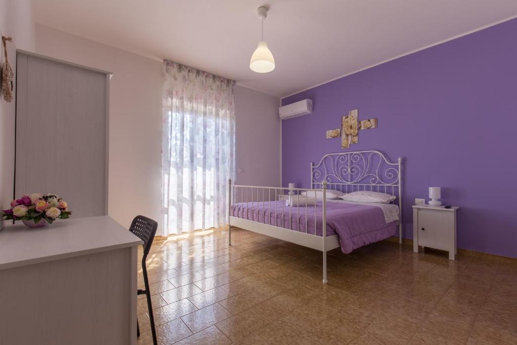 カザルボルディーノにあるAlbatrosの紫の壁のベッドが備わる紫のベッドルーム1室が備わります。
