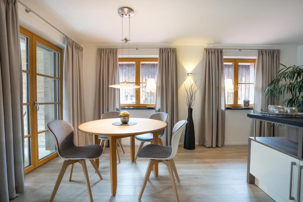 a dining room with a table and chairs at Alpin Lodge in Oberstdorf