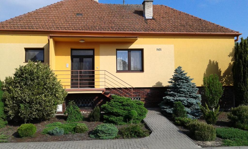 a yellow house with a garden in front of it at Zdeňka in Vracov