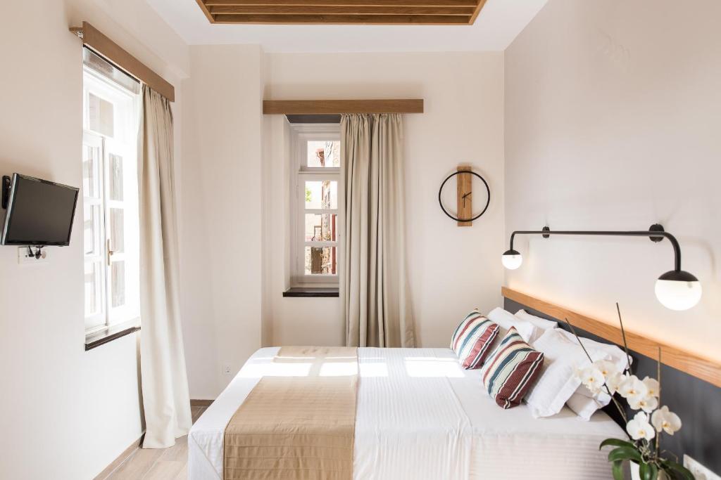 Postel nebo postele na pokoji v ubytování Harismari Cozy Hotel
