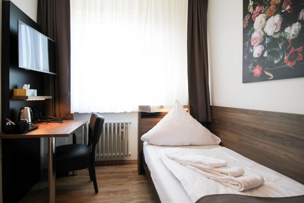 Ein Bett oder Betten in einem Zimmer der Unterkunft Center Hotel Essen