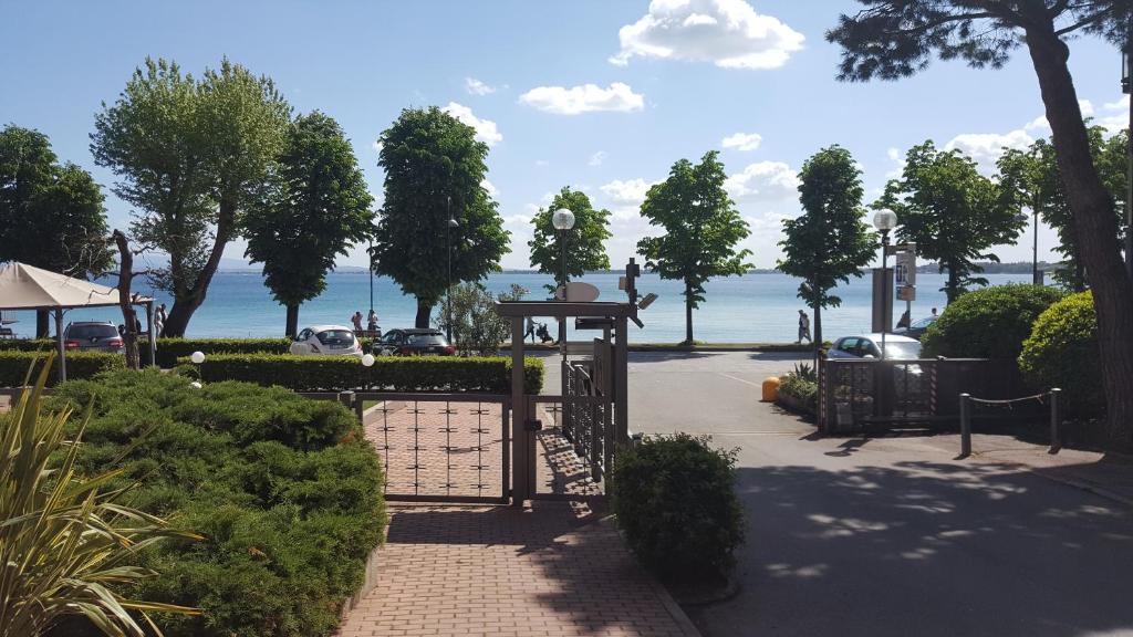 a gate in a park with a view of the water at Le Rive in Desenzano del Garda