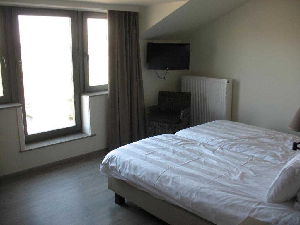 Postel nebo postele na pokoji v ubytování B&B La Vie En Roses